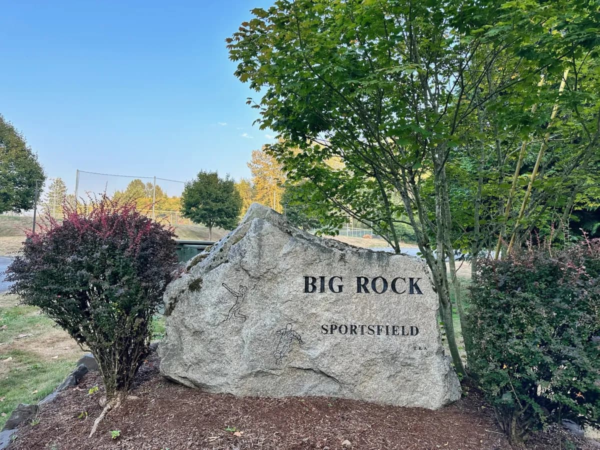 Big Rock Sportsfield boulder sign with ball fields in the background in Duvall WA
