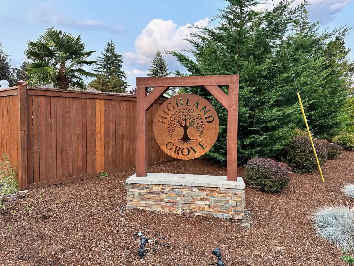 Highland Grove corten steel Tree of Life medallion on timber pergola entry in Duvall WA