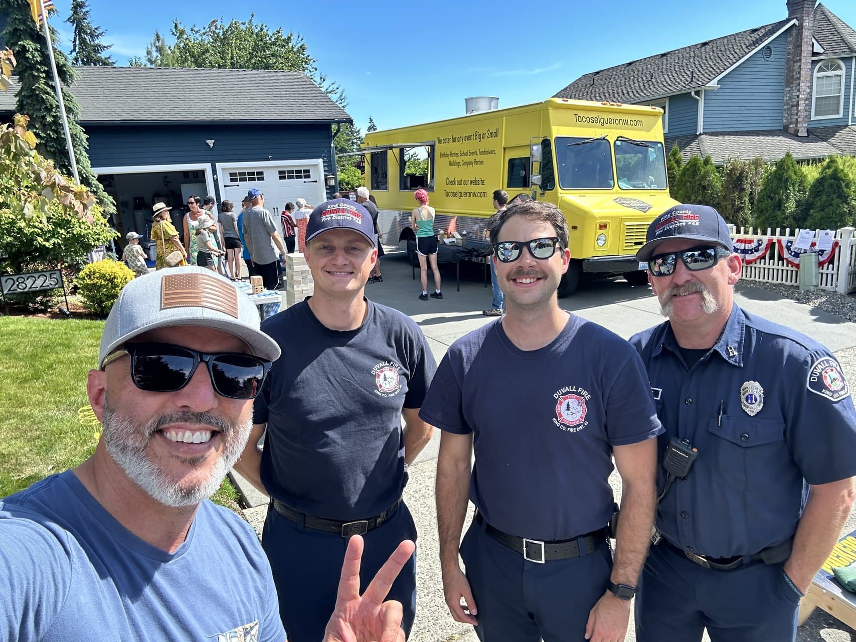 Buddy Buck with three Duvall firefighters at a neighborhood block party